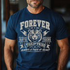 A man wearing a navy blue t-shirt with a vintage-style white graphic featuring a tiger, lightning bolts, and the text 'FOREVER EST. 1954 HAYSI TIGERS TIGER PRIDE ALWAYS A TIGER AT HEART'.