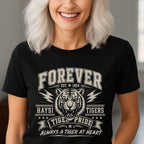 A smiling woman with platinum blonde hair wearing a black short-sleeve graphic t-shirt. The shirt features a white distressed print of a tiger head and the text 'FOREVER HAYSI TIGERS EST 1954 TIGRE PRIDE ALWAYS A TIGER AT HEART'.