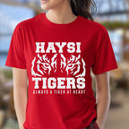 A woman wearing a bright red short-sleeve t-shirt with a distressed white graphic that reads 'HAYSI TIGERS ALWAYS A TIGER AT HEART' with a tiger face.