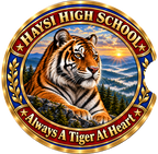 A circular school emblem for Haysi High School featuring a detailed illustration of a tiger resting in a mountain landscape at sunrise. The design has a gold border, red outer ring with gold lettering reading 'HAYSI HIGH SCHOOL' and 'Always A Tiger At Heart', and blue inner details.